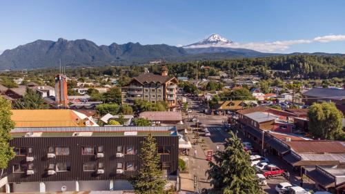 an aerial view of a town with a mountain in the background at Mawün Hotel Pucón in Pucón