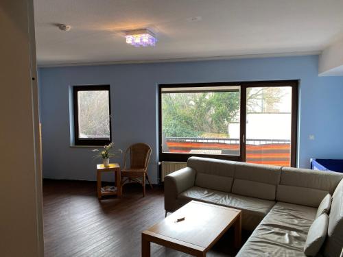 a living room with a couch and two windows at Marktschänke in Bad Dürkheim