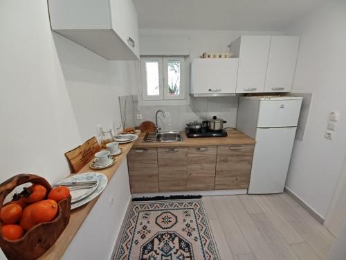 a kitchen with a bowl of fruit on a counter at Kiki's Apartments in Barbati