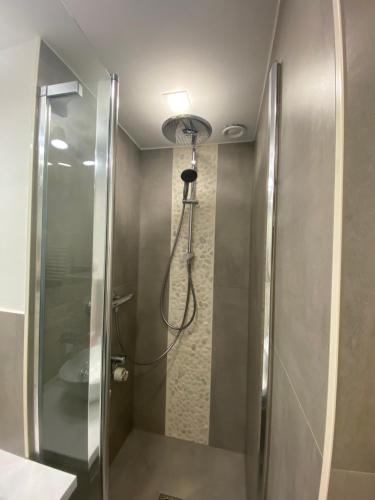 a shower with a glass door in a bathroom at Seeblickapp. „Eure Auszeit“ in Goslar