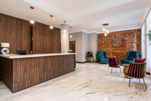 a lobby with a reception desk and chairs at Old Riga Plaza Hotel in Rīga