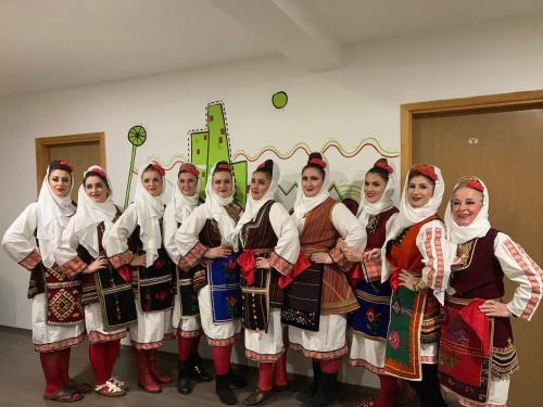 a group of women dressed in traditional clothing posing for a picture at Hostel Room in Banja Luka