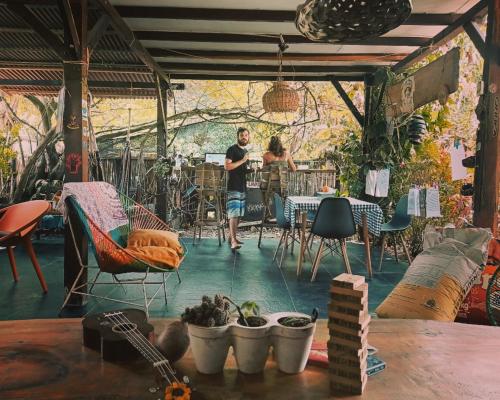 a man standing in a room with a table and chairs at La happycleta in Palomino