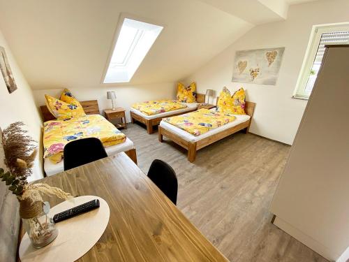 a living room with two beds and a table at Seehaus Mamming - Hotel - Schlaffässer - Biergarten - Camping in Mamming