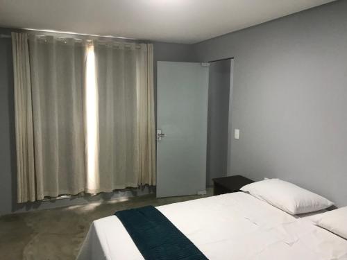 Postel nebo postele na pokoji v ubytování Pousada Ohana Dullius