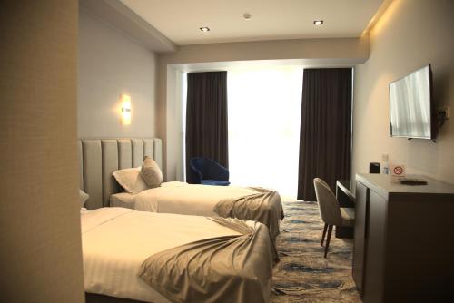 Ένα ή περισσότερα κρεβάτια σε δωμάτιο στο UNIQUE HOTEL