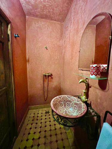a pink bathroom with a sink and a shower at Kasba blanca in Tangier