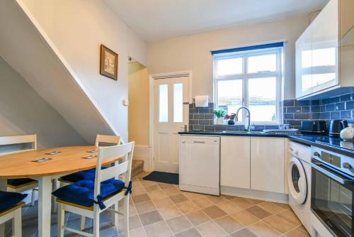 a kitchen with a table and a sink and a stove at Bay tree Cottage in York