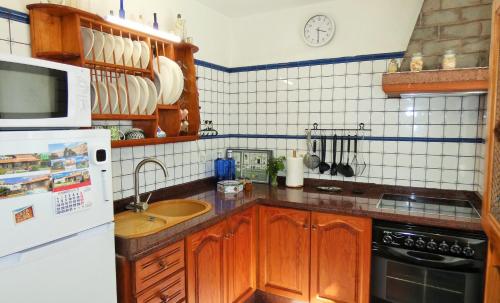 a kitchen with a sink and a refrigerator at Casa Elba in Isora