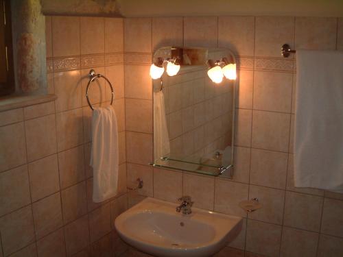 a bathroom with a sink and a mirror at Villa Karissa - Zante in Vasilikos