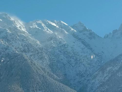 a snow covered mountain with a sign on it at MAA BHAGWATI HOME STAY in Kalpa