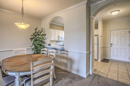 a kitchen and dining room with a table and chairs at 7 Mi to Myrtle Beach Boardwalk Condo with Balcony! in Myrtle Beach