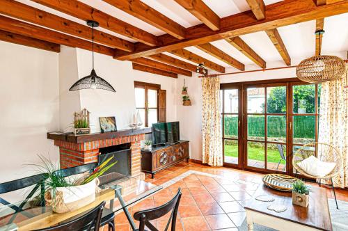 a living room with a table and a fireplace at Casa Sabina, Zona de playa y montaña in Llanes