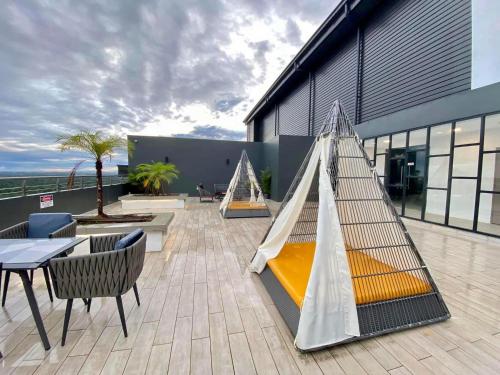 a hammock on the roof of a building at Premium Swanhouse no.SiX with 3bedrooms Condo in Sibu