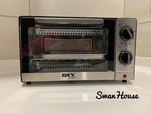 a toaster oven sitting on top of a counter at Premium Swanhouse no.SiX with 3bedrooms Condo in Sibu