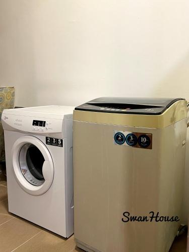a dryer and a washing machine in a room at Premium Swanhouse no.SiX with 3bedrooms Condo in Sibu