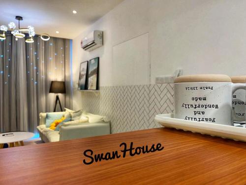 a coffee cup sitting on a counter in a living room at Premium Swanhouse no.SiX with 3bedrooms Condo in Sibu