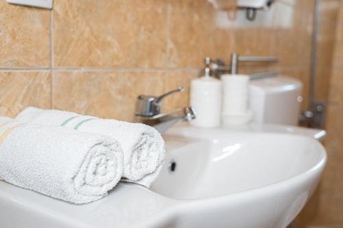 a bathroom with a sink and a white towel at Apartments Sejla in Ulcinj