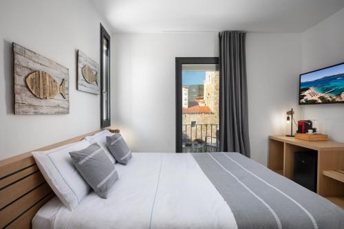 a bedroom with a large bed and a window at The Square Cannigione in Cannigione