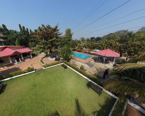 an aerial view of a yard with a swimming pool at Karjat retreat 4bhk pvt farmhouse in Karjat