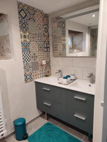 a bathroom with a sink and a mirror at Les tilleuls de Mary in Rillé