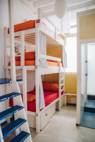 a room with three bunk beds in a room at Casa Caracol in Cádiz