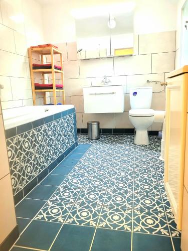 a bathroom with a tub and a toilet and a sink at Ferienhaus Dr. Müller in Meißen