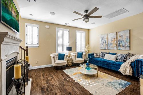 a living room with a blue couch and a fireplace at Luxury & Highly furnished upscale w Patio & Garage in Plano
