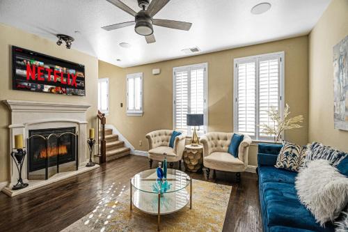 a living room with a blue couch and a fireplace at Luxury & Highly furnished upscale w Patio & Garage in Plano
