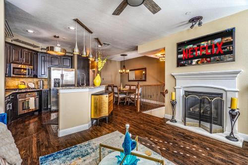 a kitchen and a living room with a fireplace at Luxury & Highly furnished upscale w Patio & Garage in Plano