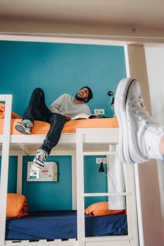 a man laying on top of a bunk bed at Casa Caracol in Cádiz