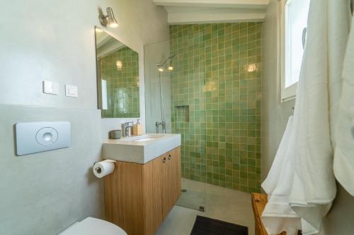 a bathroom with a sink and a mirror at Casinha da Cabra, Casas do Poente, Rogil, Aljezur in Aljezur