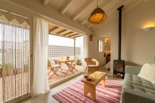 a living room with a couch and a table at Casinha da Cabra, Casas do Poente, Rogil, Aljezur in Aljezur