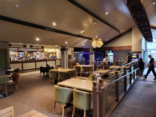 a restaurant with tables and chairs and a bar at Cheerful 3 bedroom Lodge At White cross Bay Windermere in Windermere