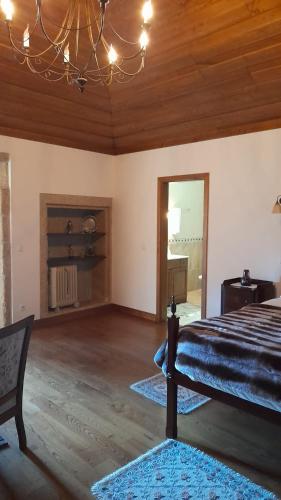 a bedroom with a bed and a chandelier at Casa Do Seminario in Gralhas