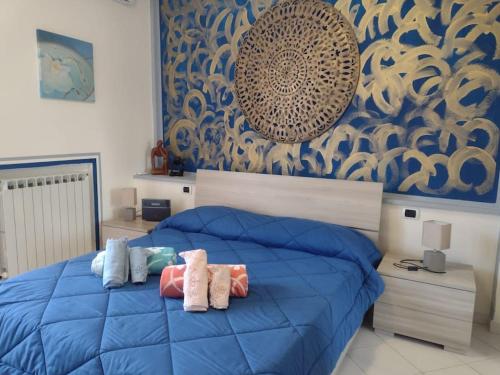 sypialnia z niebieskim łóżkiem z poduszkami w obiekcie Casita LERICI w mieście Lerici