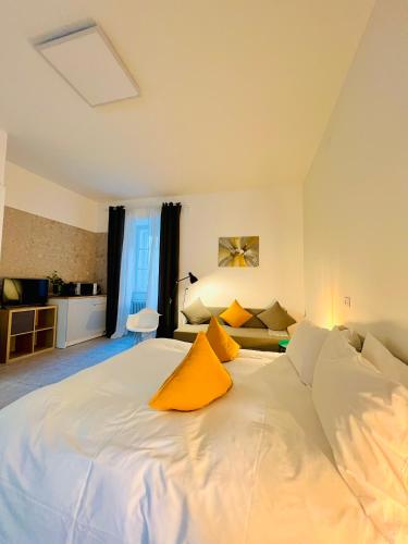 a bedroom with a large white bed with yellow pillows at Crops City Stay in Trieste
