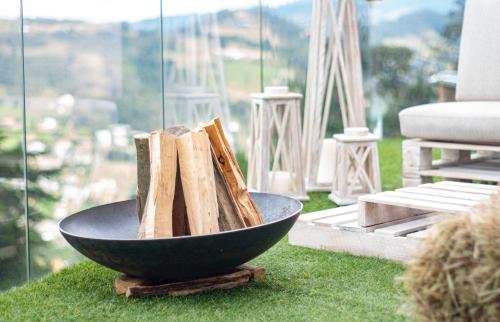 a bowl filled with wood sitting on top of green grass at Sukha Resort in La Calera