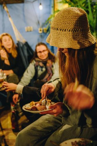 a group of people sitting around eating food at Casa Caracol in Cádiz