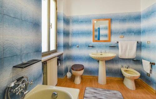 a blue and white bathroom with a sink and a toilet at Casa di Cristian in Pian di Mulino