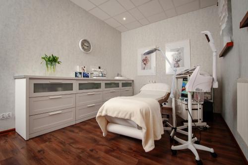 a hospital room with a bed and a chair at Hotel Chopin Business&SPA in Sochaczew