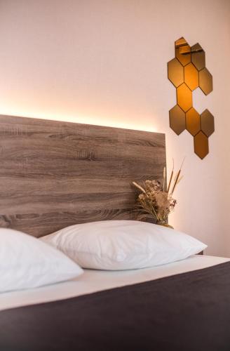 a bedroom with a bed with a wooden headboard at Hotel Du Commerce in Oostburg