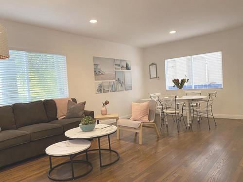 a living room with a couch and a table at Malibu Private Beach Apartments in Malibu