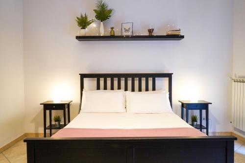 a bedroom with a bed with two night stands at The Good Place B&B in Rome