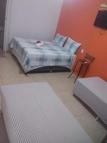 a bedroom with a bed with a cat laying on it at pousada jalapão arco iris in Mateiros