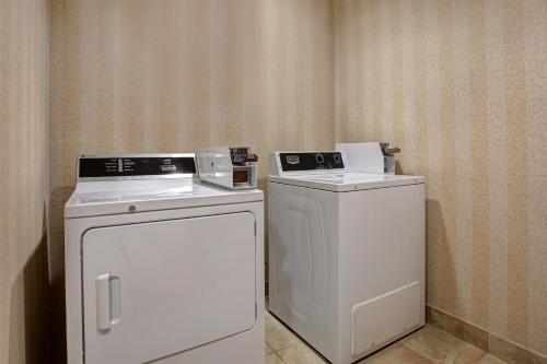 a laundry room with a washer and a dryer at Days Inn & Suites by Wyndham Collingwood in Collingwood