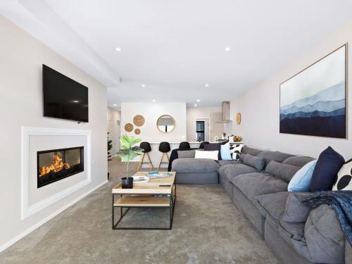 a living room with a couch and a fireplace at St Matthews Views Cecil in Queenstown