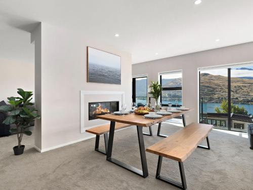 a dining room with a table and a fireplace at St Matthews Views Cecil in Queenstown