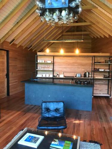 a room with a bar with a table and a chair at Luxury mountain loft in Pucón