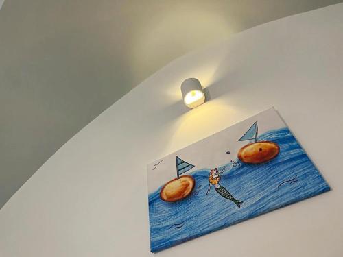 a drawing of two donuts on a wall with a candle at La stella di Chanel in Nardò